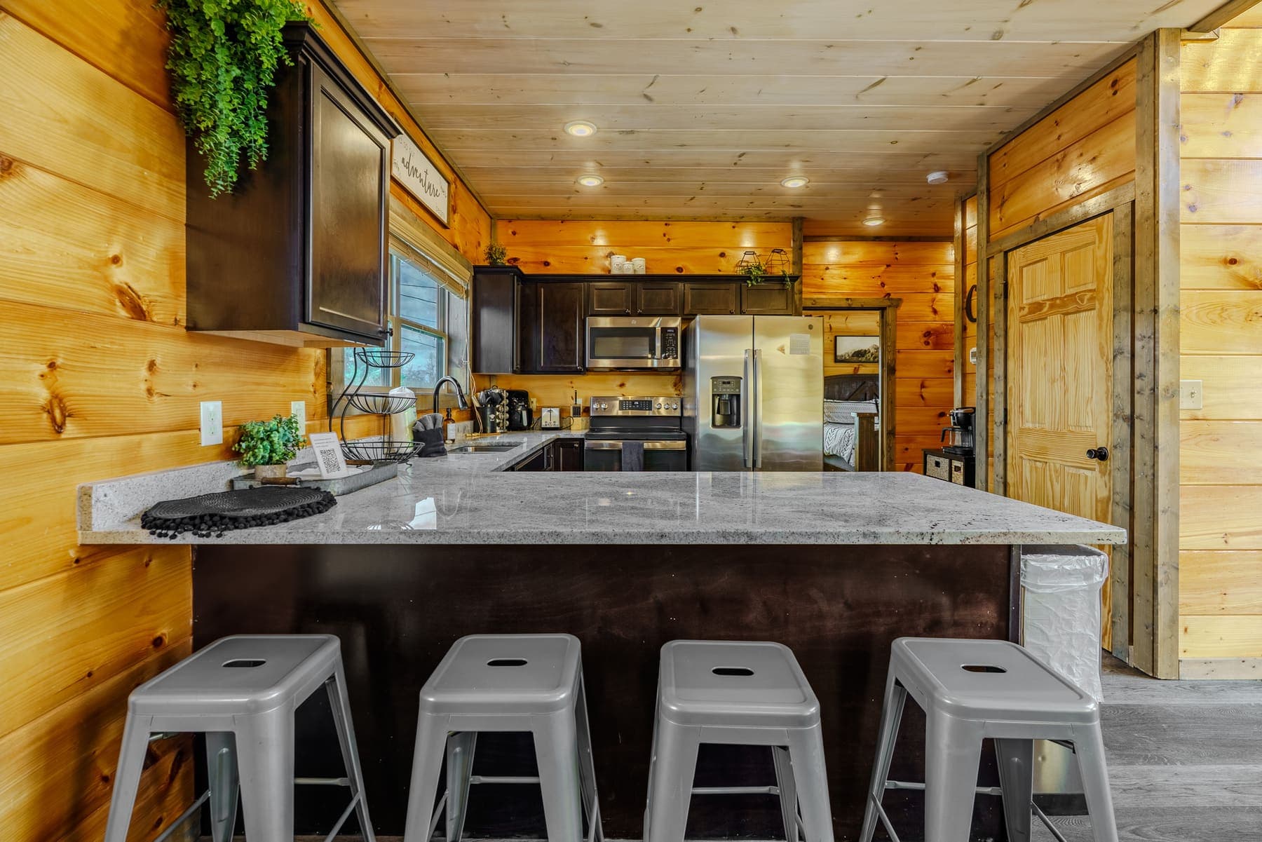 Kitchen breakfast bar with granite counter and four stools
